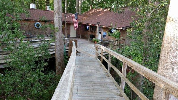 View coming down a few steps and bridge from upper street side, hwy 292, parking lot.