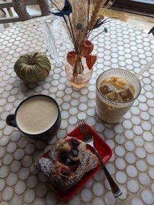 On the left is a Pumpkin Spice Chai and on the right an Iced Pumpkin Latte with a toasted Blueberry Cream Danish.