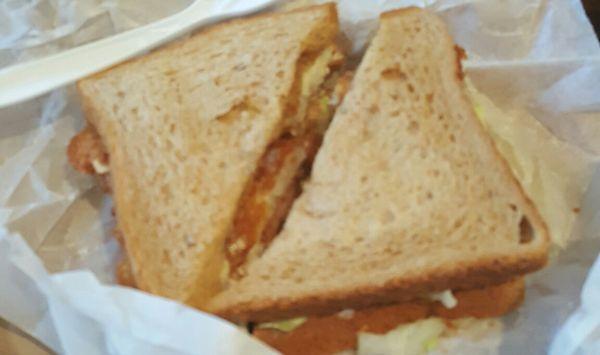 Fried chicken sandwich on whole wheat and with tomato, lettuce, onion, mayo. Side of fries.