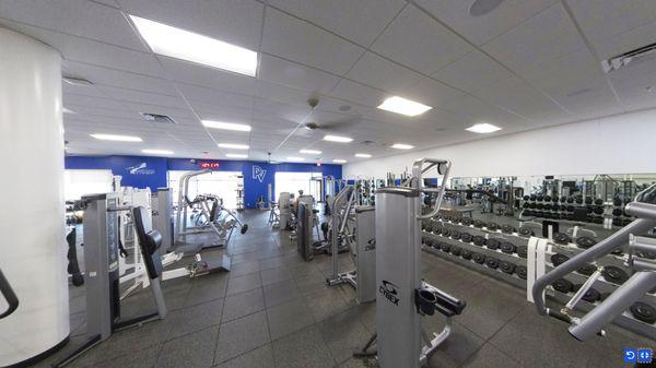 Free weight workout area and cable machines for strength training.