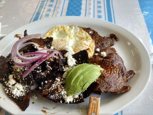 Chilaquiles with mole, carne asada and eggs