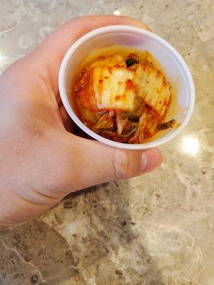 Complimentary kimchi in a small cup. Homemade, yum!