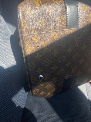 Missing button and obviously not leather or real Louis Vuitton