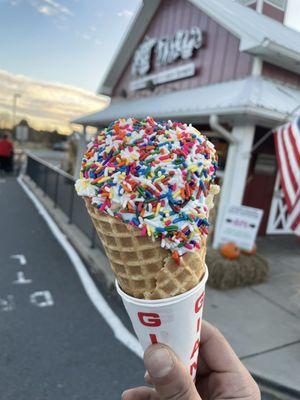 Sweet cream waffle cone with rainbow sprinkles