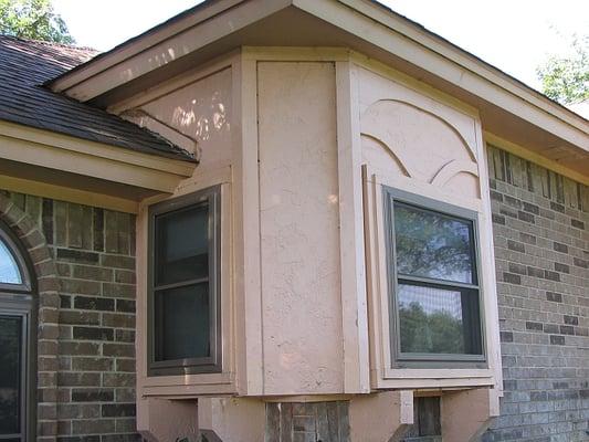 Outdated Siding (Before). Damaged or outdated features could benefit from a brick or stone accent upgrade.