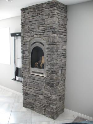 Bed & Breakfast DV gas fireplace from FireplaceX done in Grey Southern Ledgestone by Boral Cultured Stone