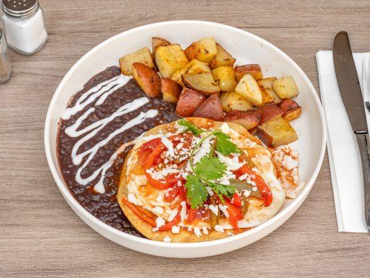 Huevos Rancheros.

Two eggs any style on top of a fried tortilla, refried beans on the side, with our special house sauce.