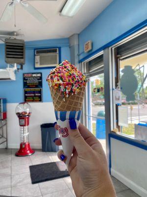 Vanilla waffle cone with rainbow sprinkles