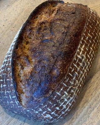 Country Loaf baked boldly --  like the sear on a good steak - dark, crispy, caramelized deliciousness.