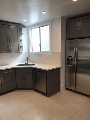 The beautiful warm grey cabinets compliment the neutral making this space feel very open and airy.