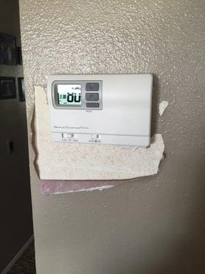 This is how they left my wall after they replaced my state of the art thermostat with this cheap one.