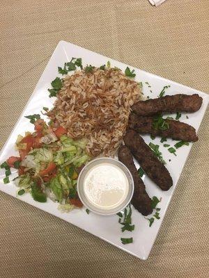 kofta kabab over rice, salad & tahina sauce