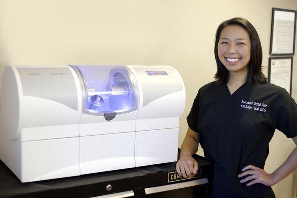 Dr. Tsai posing with our mill-- modern technology used to make same day crowns