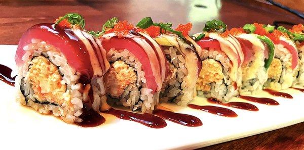 Vista Roll~~Real crab meat, avocado, spicy sauce topped with tuna, eel sauce, sesame dressing, chili oil, masago and green onions.