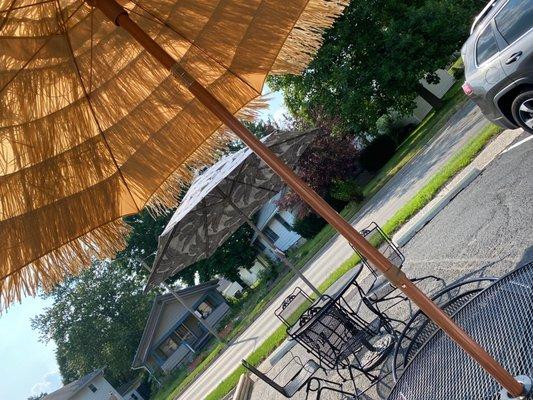 Two out of four covered with umbrella tables.