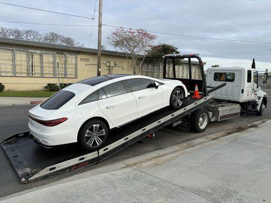 Car on truck. It was eventually leveled out to be driven to its location.