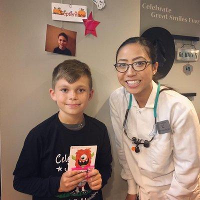 Dr. Cathy congratulates our September's No Cavity Kid Club winner. Way to go!