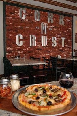 Enjoy pizza and a glass of wine at the Cork N Crust.