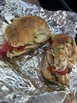 Garlic knot chicken pesto sandwich with fresh mozzarella and roasted red peppers