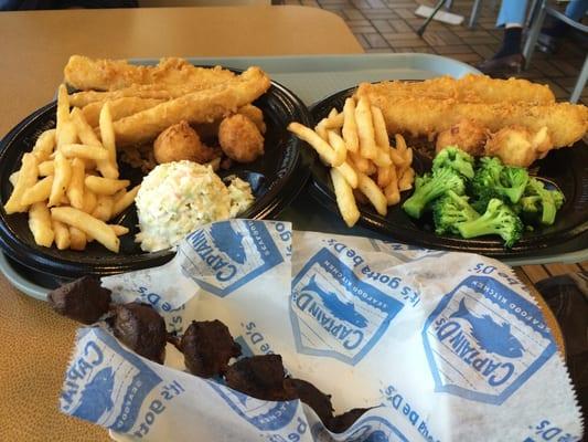 Fish, fries, broccoli, hush puppies, and a beef skewer.