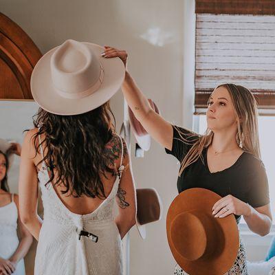 Owner Jessica showing different styling options including hats