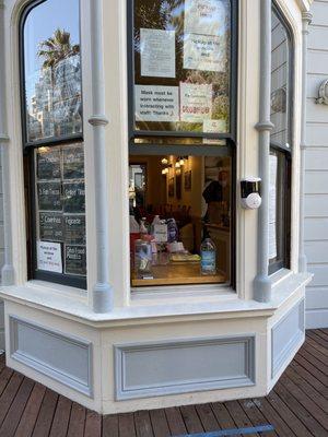 Cute takeout window with the wall mounted hand sanitizer