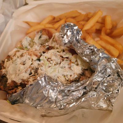 Chicken soulvaki wrap with fries, add tzaziki