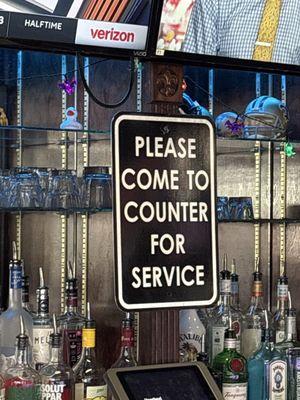 Come to the bar for service (if this sign isn't obvious)