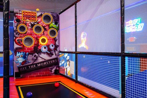 Ball throwing game inside trampoline park.