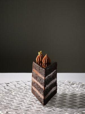 K+M Nicaragua Dark Chocolate Layer Cake: traditional blackout cake layered with a rich crémeux, glazed with old fashioned icing, gold leaf