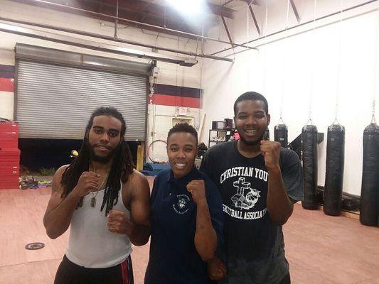 Coach and trainees after boxing combat training.