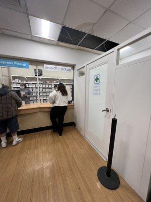 Pharmacy line, missing ceiling panels and water stains