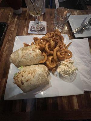 Buffalo chicken wrap with curly Fries.