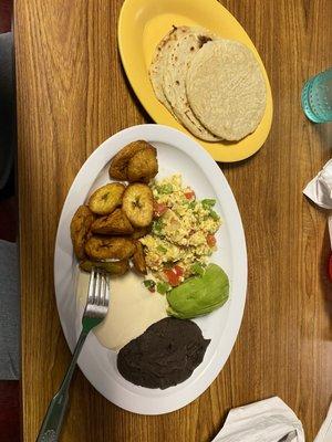 Fried Plantain, Scrambled eggs, cream, avocado and refried beans