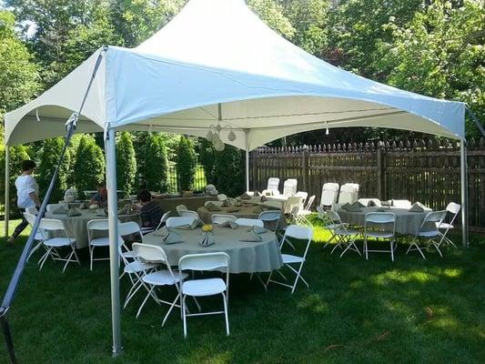 Our 20x20 High Peak Tent with 60" round tables and white folding chairs