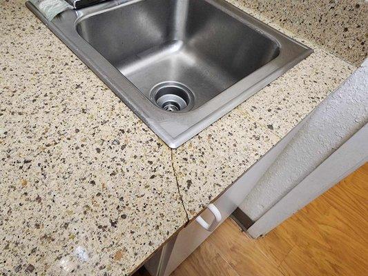 broken countertop in kitchenette