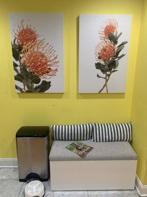 Custom printed acoustic panels do double duty as art, and a bench to hang out on