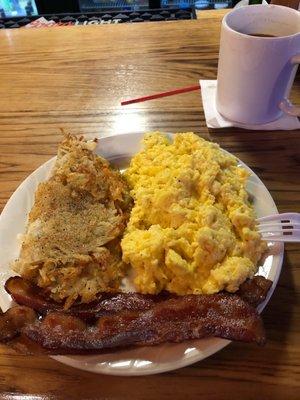 In house recipe cheesy garlic scrambled eggs w/ bacon and hash browns. YUM