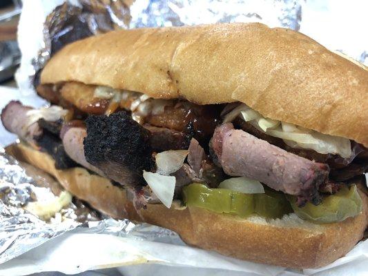 The Longhorn Hoagie: brisket sandwich with onion rings, onions, pickles, and hot BBQ sauce