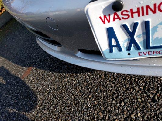 Bent front plate, after putting it back in place. Was at a 90 degree angle out of the car wash