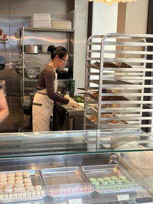 Lauren portioning a loaf of pandan coffee cake.