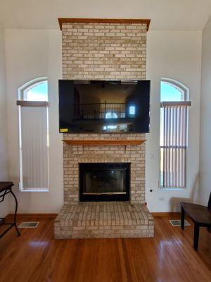 70" tv mounted above Fireplace