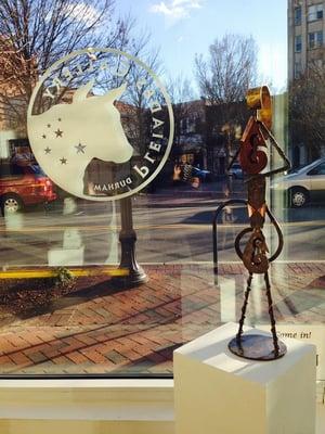 Pleiades Logo in the front window, and a steel and copper sculpture made for the TransFORM show.