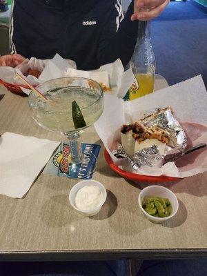 Shredded beef burrito with margarita on the rocks