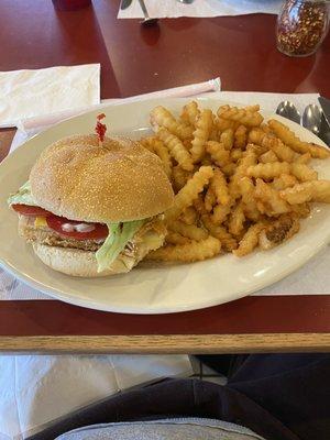 Fish Sandwich with cheese, tomato,lettuce and tartar sauce. Crinkle cut fries.