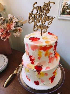 Custom cake with smear design in peaches, pinks, yellows, and reds