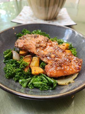 Glazed salmon on kale w sweet potatoes, butternut squash, and onions.