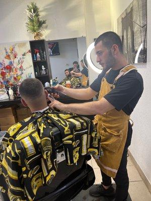 The barber cutting up a a client. He can cut all types of hair from straight to curly.