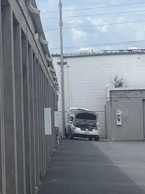 Fixing up her car when the sign clearly says no soliciting, private property.