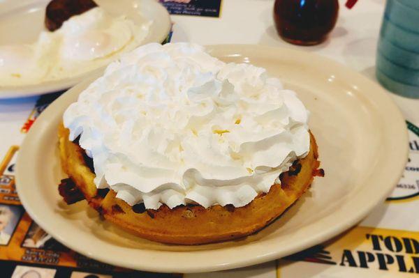 Bacon and pecan Belgian Waffle with whip cream.